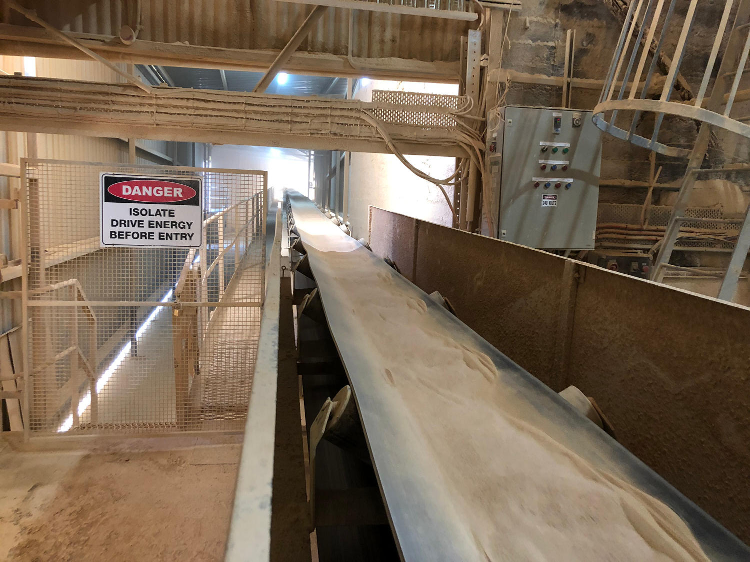 Agricultural lime on conveyor belt at mining plant